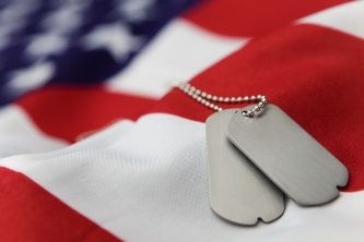 Blank dog tags on American flag with focus on tags - Shallow dof