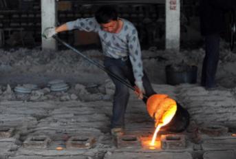 A Chinese worker pours molten steel into the casters at a small iron and steel mill in Hefei, central China's Anhui province on June 19, 2010. China, the world's leading iron ore consumer, saw imports surged 41.6 percent to 627.8 million tonnes in 2009 on soaring demand from steel mills. CHINA OUT AFP PHOTO (Photo credit should read STR/AFP/Getty Images)
